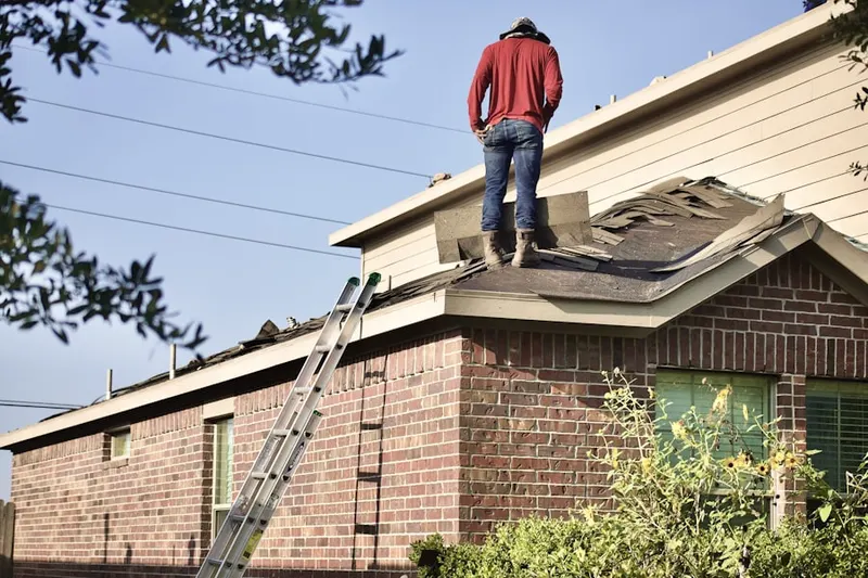 Professional roofer working on a residential roof in Town Center
